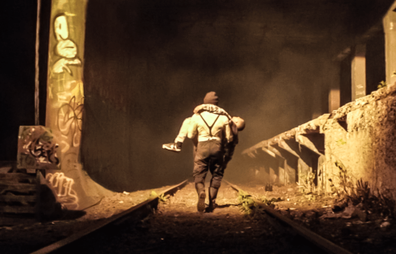 Muse carrying a man down a train track in New York City in Daredevil: Born Again